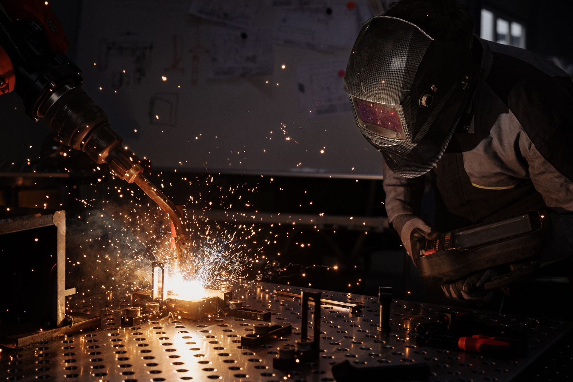 Proceso de soldadura en un taller con chispas volando durante la fabricación de metales