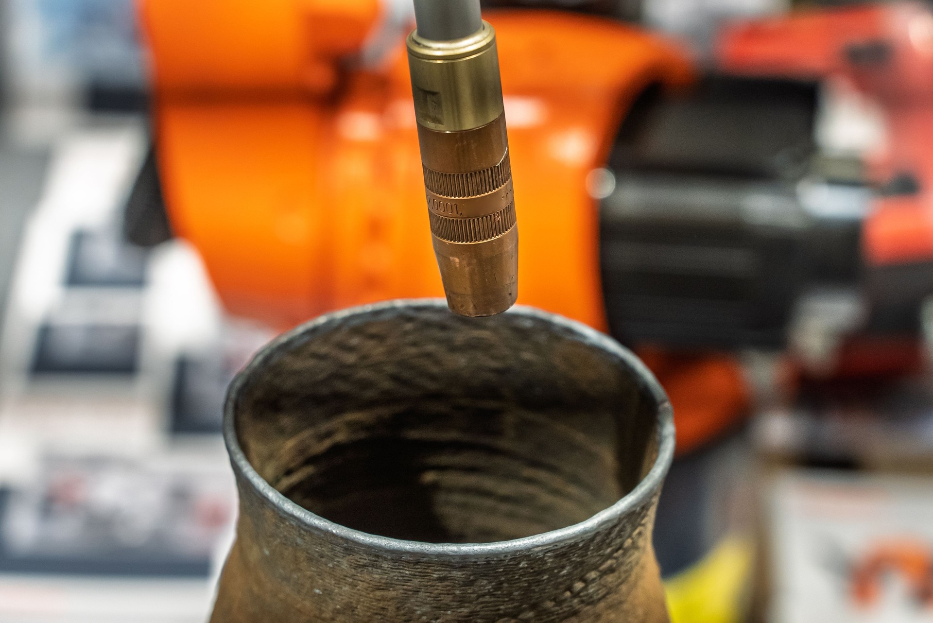 Robot welding steel. Industrial welding robot and working with metal parts. Robot welds steel. Welding head. Welding robot. CNC welding. Robotization and automation of the welding process.